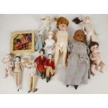 An assortment of small and miniature dolls, mostly