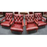 A set of four leather club chairs in claret, button-back, padded arms, turned supports and legs.