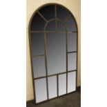 A palladian style wall mirror with an arched, architectural metal frame, 110 x 206cm.