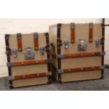A pair of graduated 'Ralph Lauren' style steamer trunks, with wooden batons and a suede and