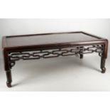 A Chinese wooden low table, well patinated with carved and pierced geometric arrows, early mid