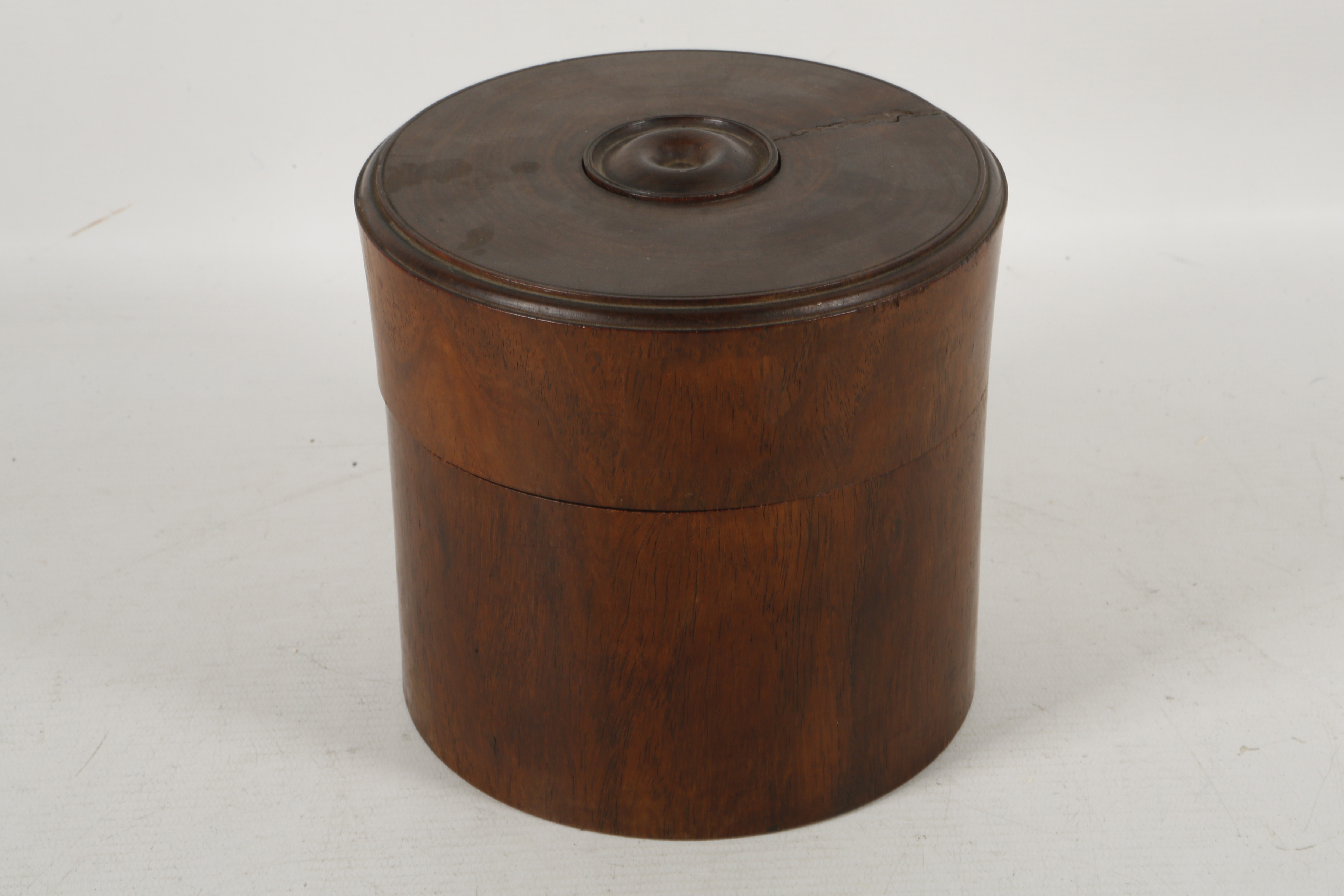 A cylindrical section bitong-form hardwood box and cover, the cover with turned decorative