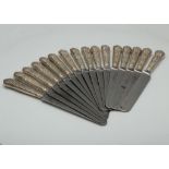 A set of sixteen Antique Edwardian Sterling Silver handled table knives by Harrison Brothers &