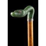 A NEPHRITE HANDLED CANE The grip is carved as a se