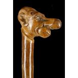 A FOLK ART BLACKTHORN WALKING STICK. With caricatu