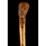 A FOLK ART BLACKTHORN 'TURK'S HEAD' WALKING CANE.