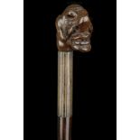 A FOLK ART ROSEWOOD CANE. With grotesque caricatur