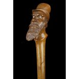 A GOOD FOLK ART HARDWOOD CANE With portrait grip o