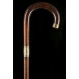 A ROSEWOOD CROOK HANDLED WALKING CANE With yellow