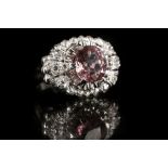 A platinum, diamond, and pink spinel ring, set rou