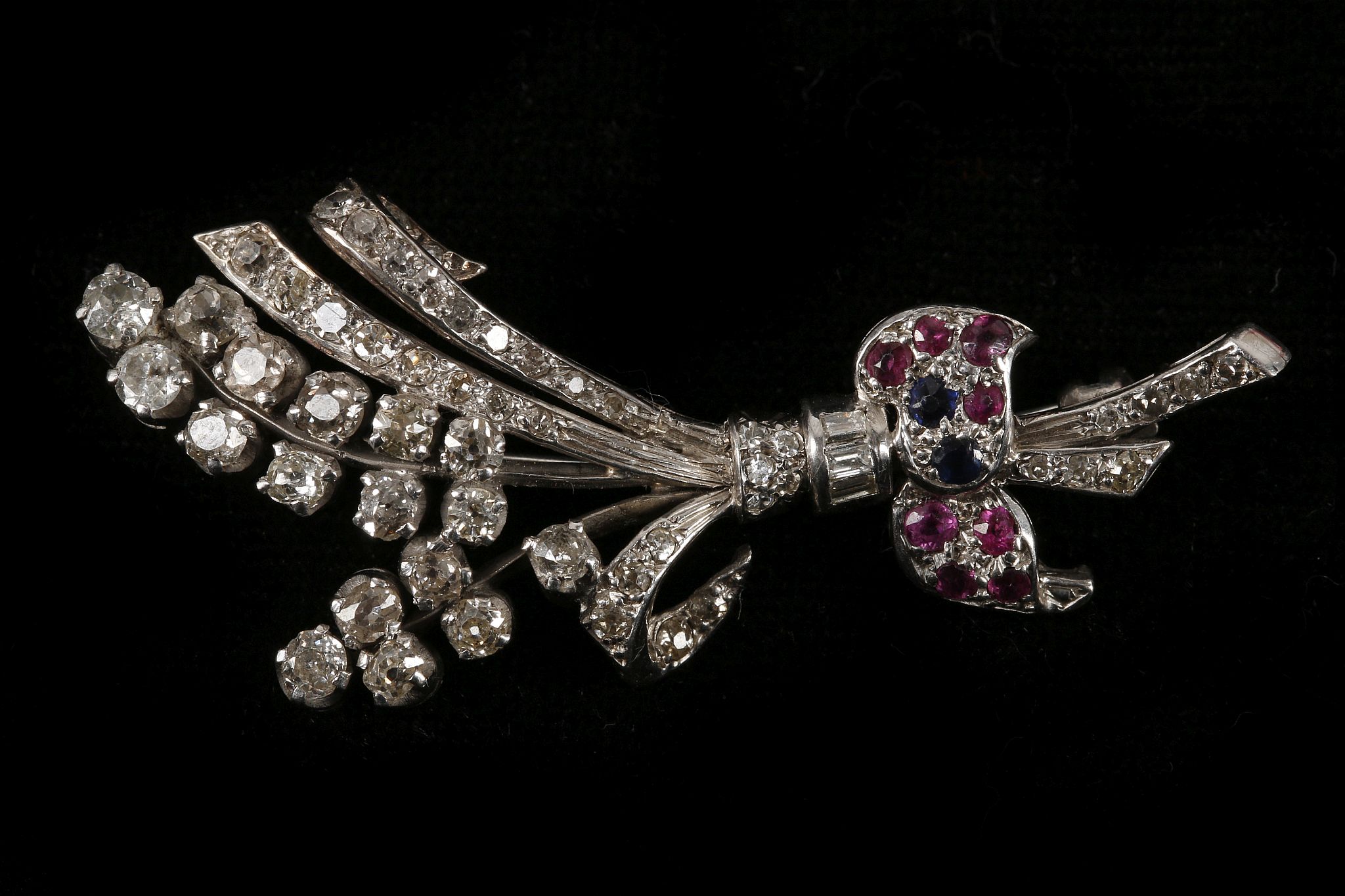 An Art Deco platinum, diamond, ruby and sapphire s