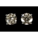 A pair of 14ik white gold and diamond studs. Diamo