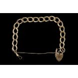 A 9ct gold large flat curb link bracelet with hear