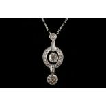 A white gold and diamond set pendant, the three graduated round cut stones set within an articulated