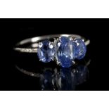 An 18 carat white gold and sapphire ring, set thre