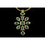 An Eastern high carat gold and emerald set pendant