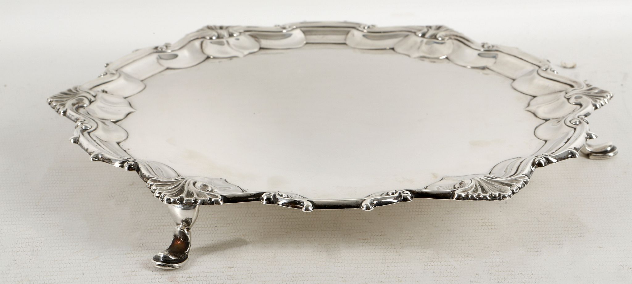 An elegant hallmarked silver salver, having pie-cr