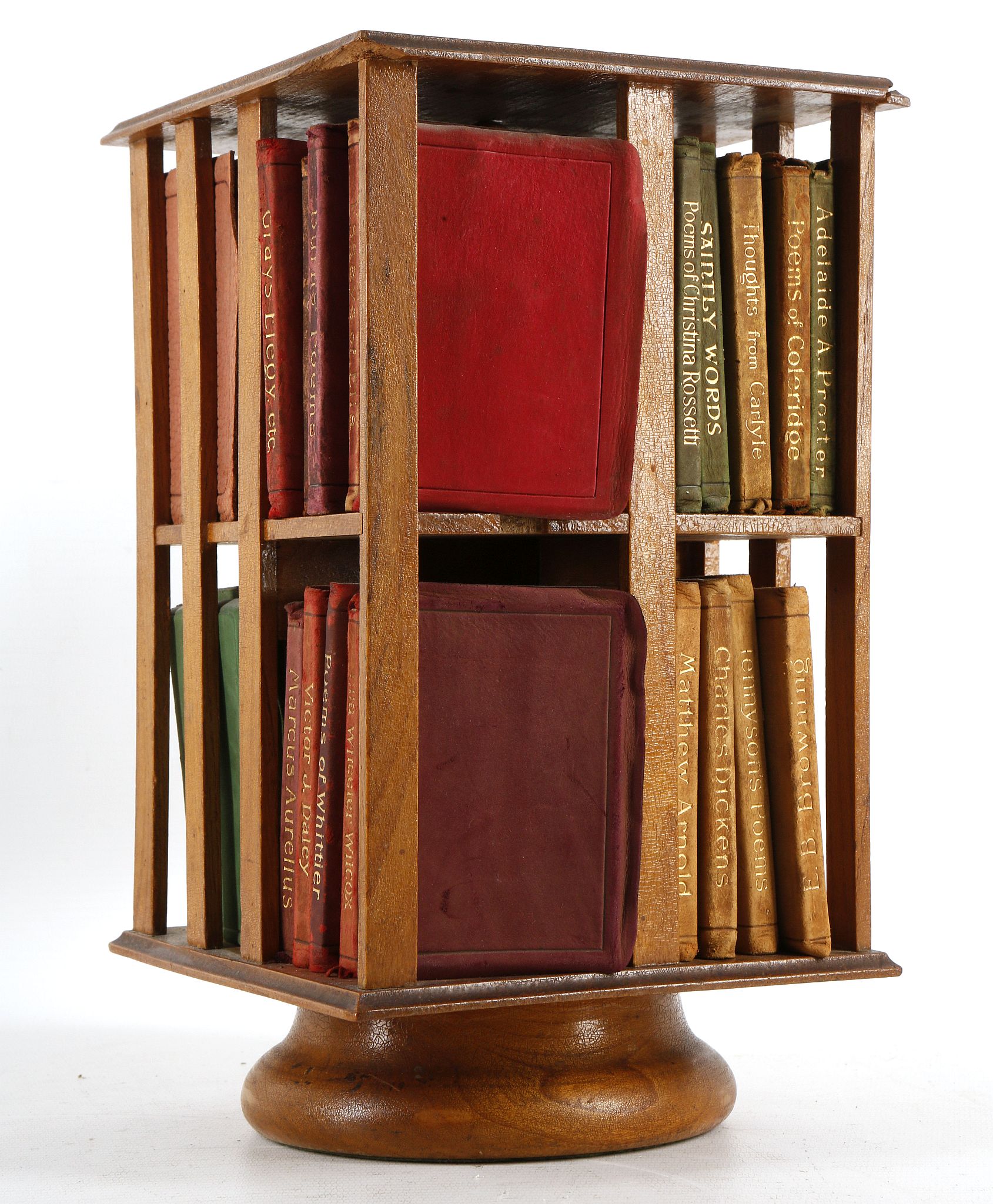 A miniature revolving two tier bookcase filled wit