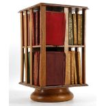 A miniature revolving two tier bookcase filled wit