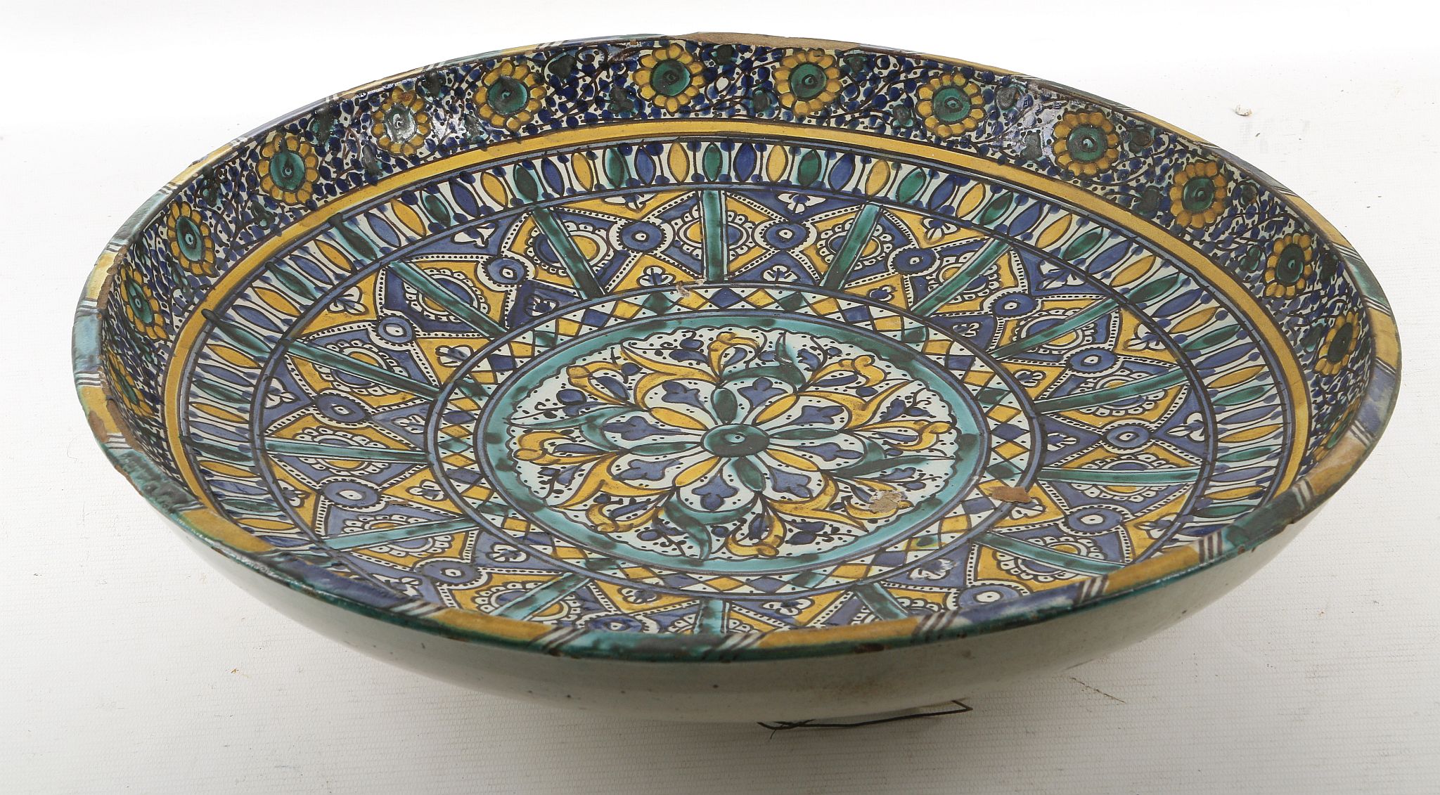 An 19th century Isnik charger, floral border, geom