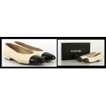 CHANEL SLIP ON SHOES, c 1989, cream leather with navy toes, flat heels, marked size 8 8, UK size