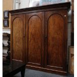 A good 19th century, mahogany triple door wardrobe with linen shelves, drawers and hanging space,
