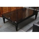A Japanese designer black lacquer tea table, bead trim, tapering box legs, brass spade feet, stamped