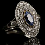 A white gold, diamond, and sapphire cluster ring, set marquise cut blue sapphire within double