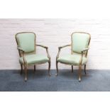 A pair of apple green, corded silk upholstered giltwood fauteuils, raised on moulded cabriole