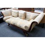 An Empire style triple seat sofa, reeded mahogany frame with swan neck roll ends and rosettes, brass