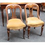 A pair of Georgian spoon-back study chairs, light oak, scroll splat, bow front seat, covered