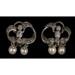 A pair of white metal, diamond, and pearl drop earrings, each set with old cut diamonds and