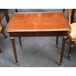 An Empire salon table, mahogany, cut corners, brass trim, later drawer, brass collars to reeded legs