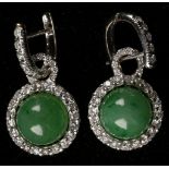 A pair of white metal, diamond, and jade cluster drop earrings, each having removable circular