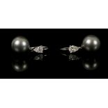 A pair of white metal, diamond, and Tahitian pearl drop earrings, each set pear-cut diamond of