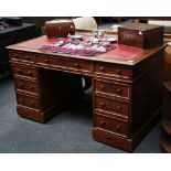 A Victorian mahogany pedestal desk with frieze drawers and three drawers to each pedestal, raised on