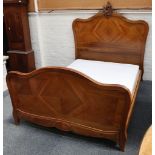 A French walnut double bed with carved rococo cresting to headboard.