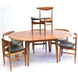 A 1960s DANISH CIRCULAR EXTENDING DINING TABLE AND