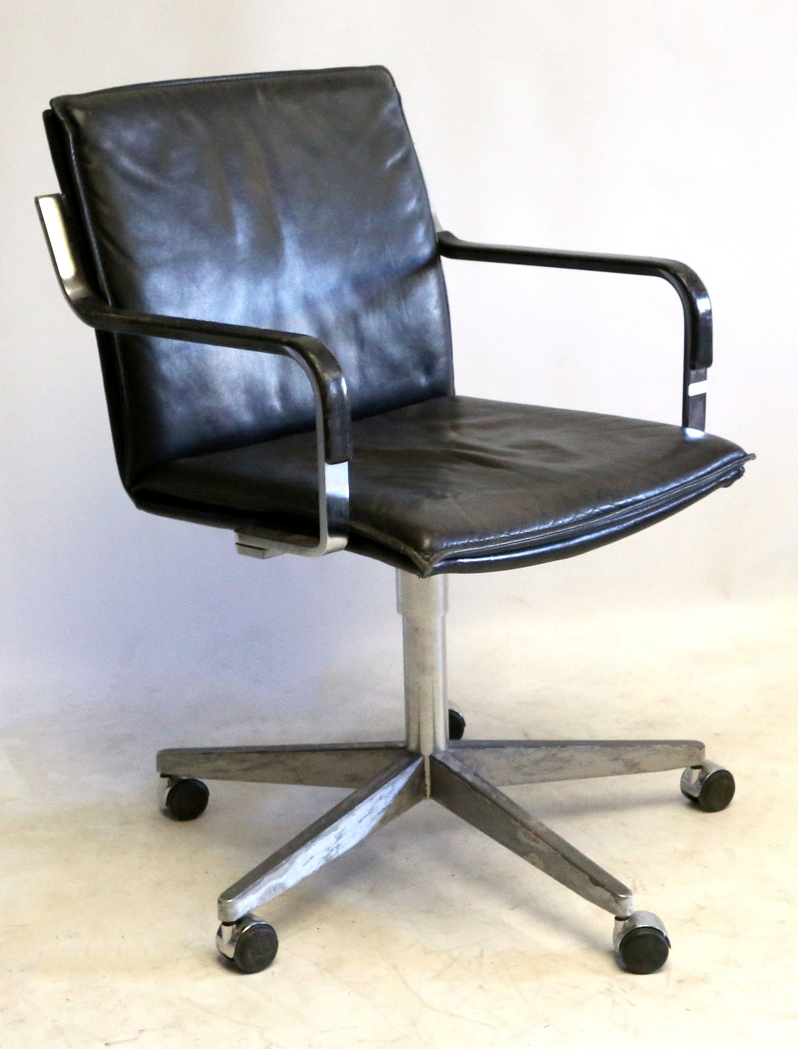 A 1970's BLACK LEATHER OFFICE CHAIR, manufactured
