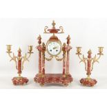 A three piece French clock garniture having gilt d