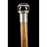 A BANDED AGATE AND HARDWOOD CANE. Circa 1900. The polished spherical top on a shaft with silver