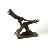 After Milo, a figural bronze study of eagles on rocky mound, one bird taking off, supported on