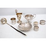 Silver napkin rings, helmet cream jug, twin handle sugar bowl, scallop shell butter dish, and a coin