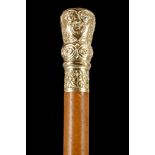 A 19TH CENTURY GOLD AND MALACCA DRESS CANE. Well chased and embossed knop, the crown engraved '