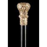 AN ELEGANT CHASED YELLOW METAL MUSHROOM KNOP HANDLED CANE. The ebony shaft with a white metal