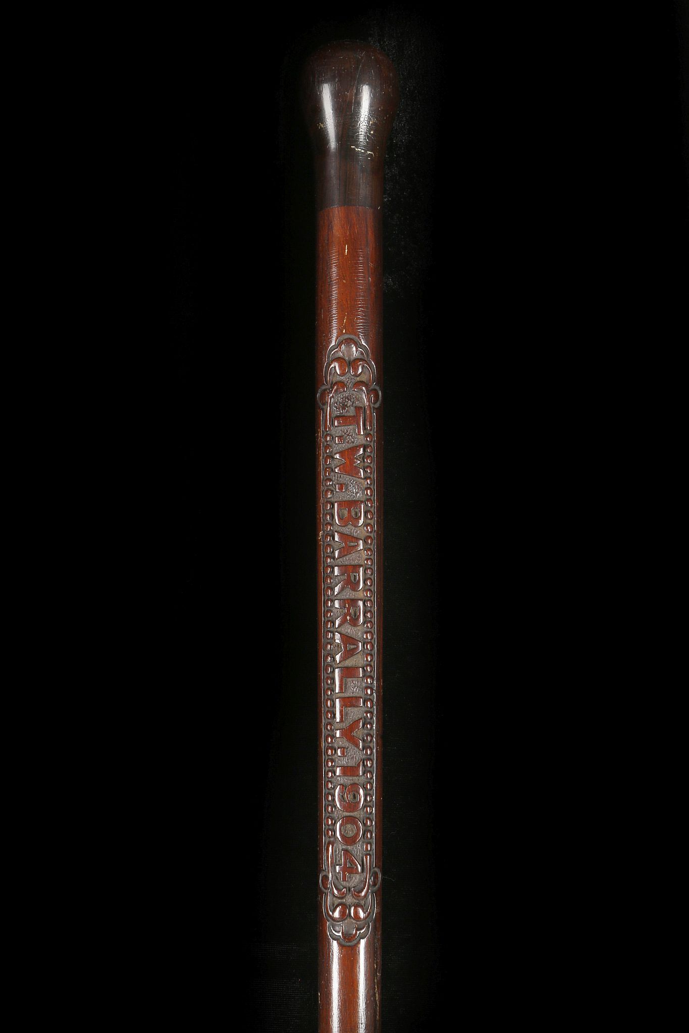 A FINE FOLK CARVED HARDWOOD WALKING CANE. With mushroom knop and the name 'T.W. Barrally' carved