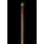 A FINE FOLK CARVED HARDWOOD WALKING CANE. With mushroom knop and the name 'T.W. Barrally' carved