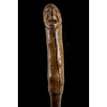 A FOLK ART HARDWOOD CANE. The handle knop carved with a portrait bus of a man wearing a Kepi, the
