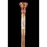 A CONTINENTAL PORCELAIN AND HARDWOOD CANE. The elongated handle with painted panels depicting an