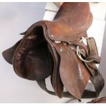 A leather saddle by Bachelor, being sold with associated bridle part, together with a pair of